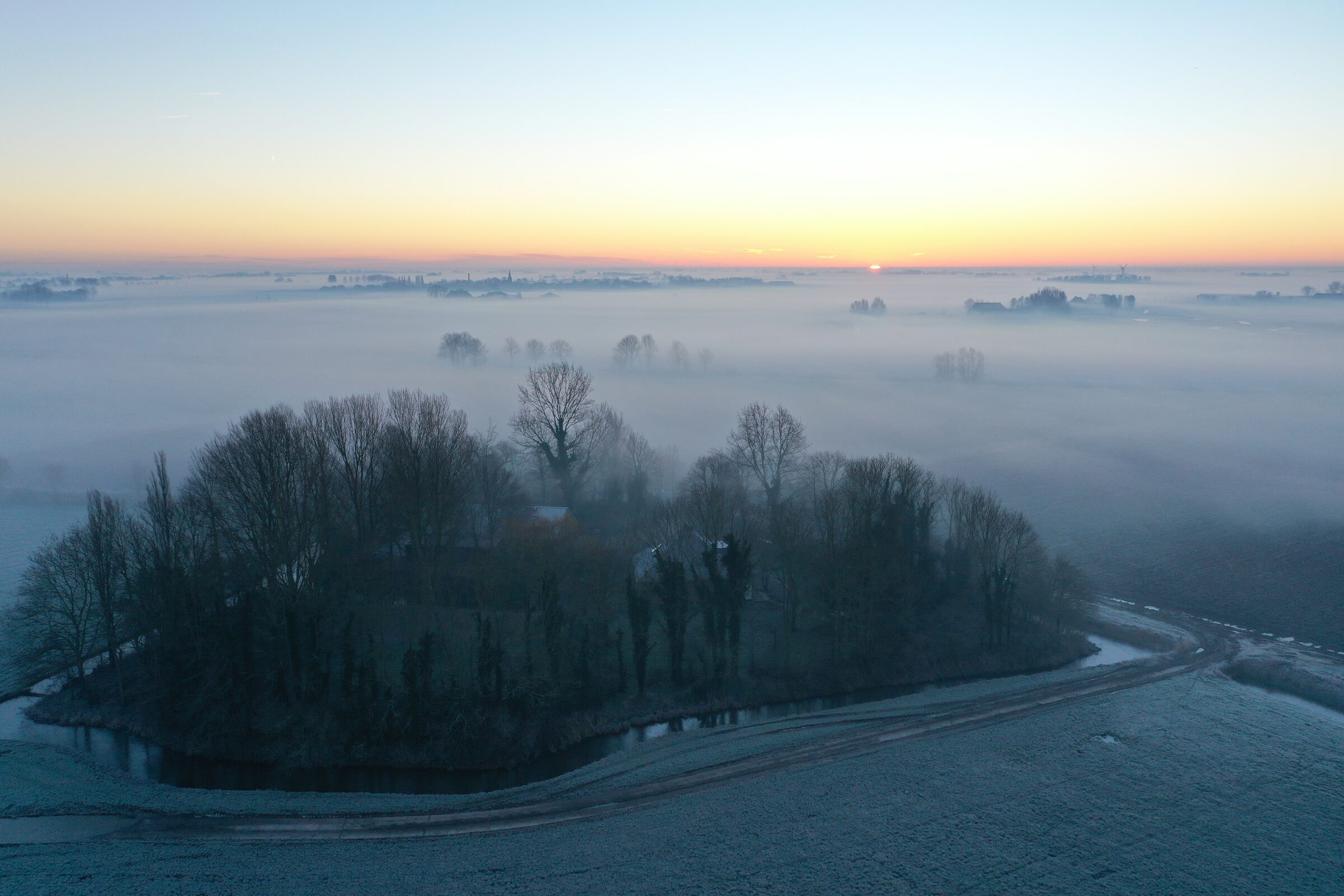 Luchtfoto van Skyldum in de mist bij zonsopkomst